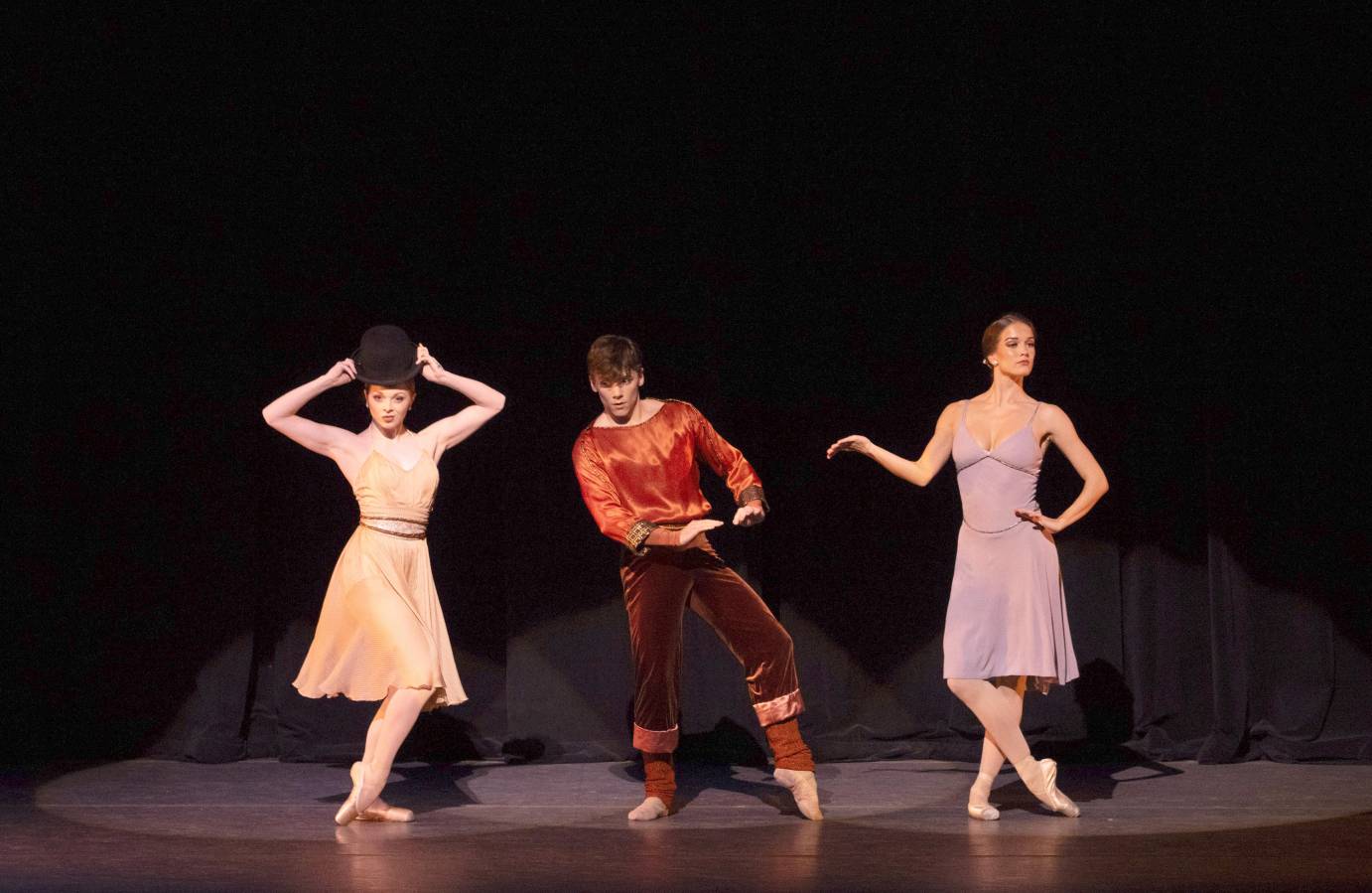 3 dancers in a line in different comical poses