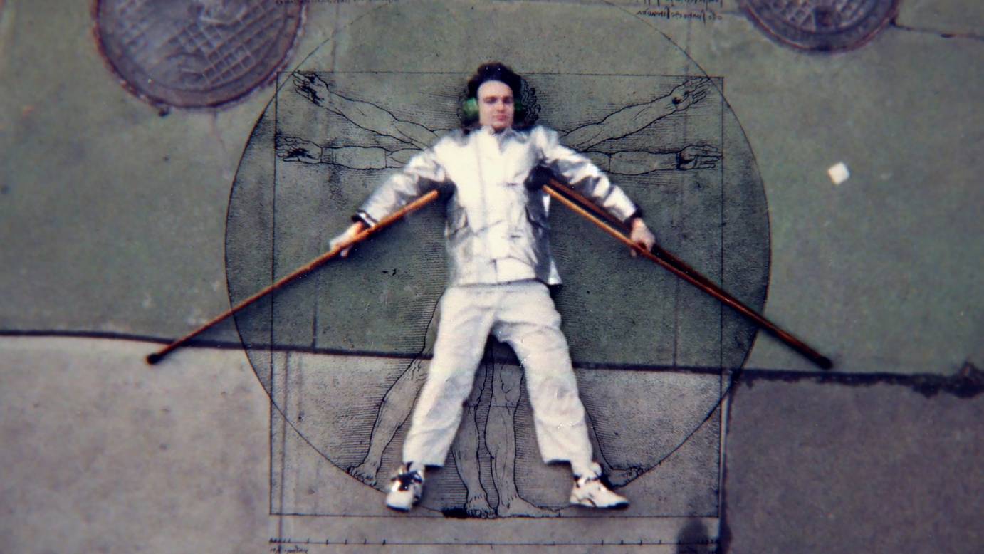 Bill Shannon lies on a sketch of Da Vinci's Vitruvian Man, his crutches extended