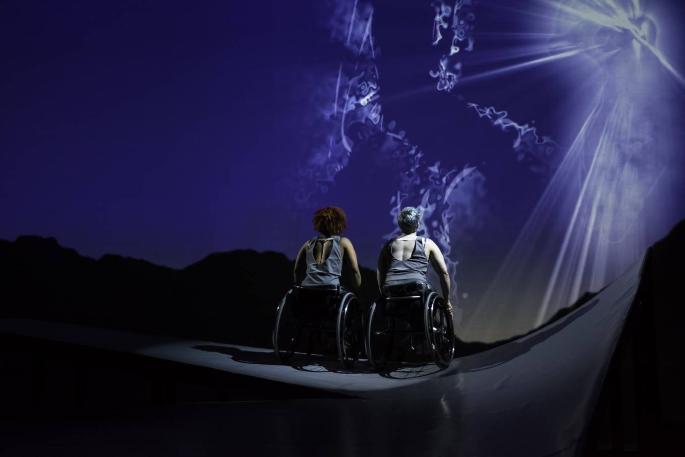 Alice and Lauren together backs facing us looking towards the stars