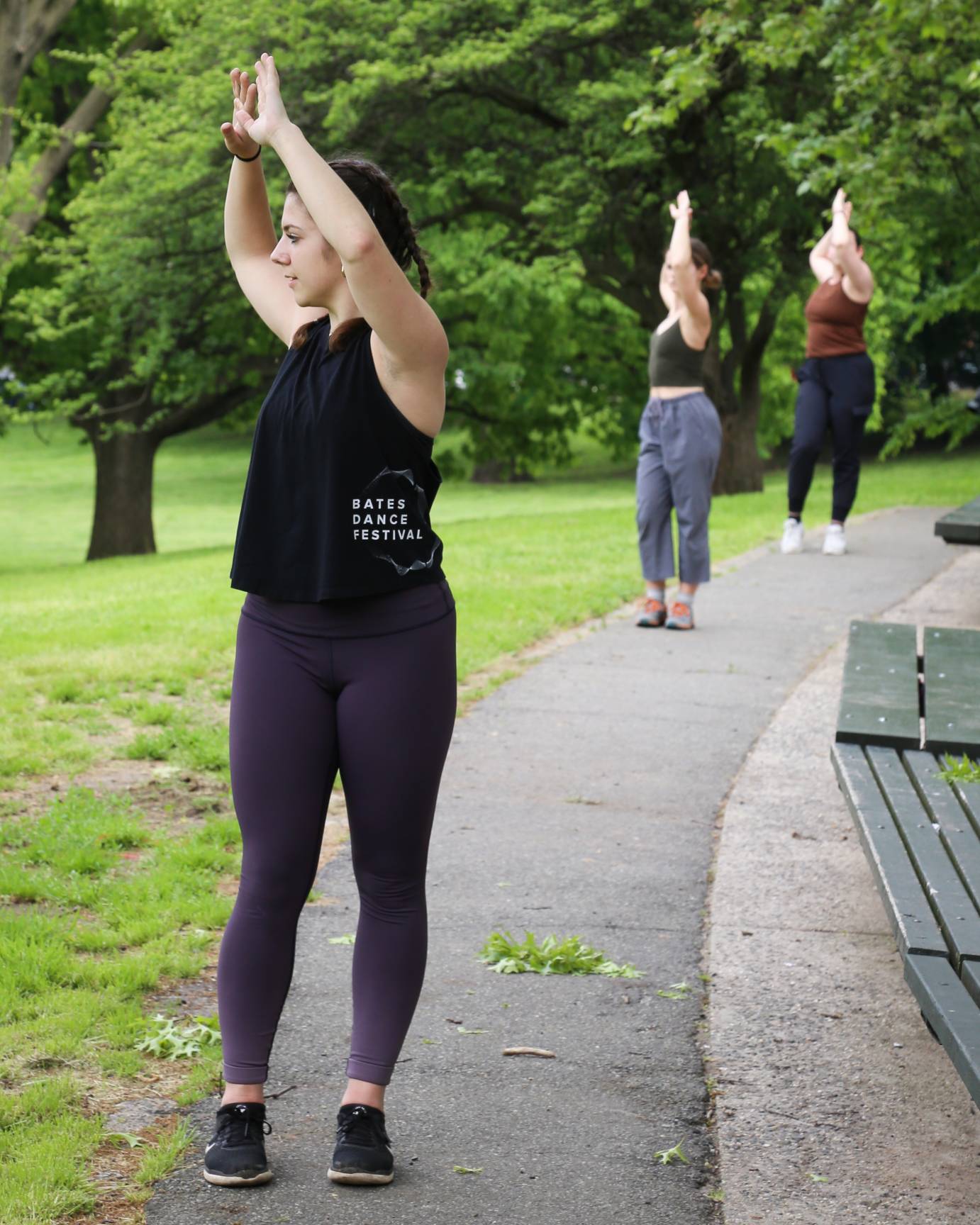 three women dancing in a line on one of Inwood Hill Park's many paths