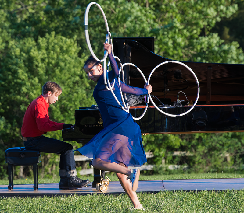 In this semi -profile, we notice ShanDien LaRance's back and her intent expression as she intertwines Native American dance to music by Claude Debussy.