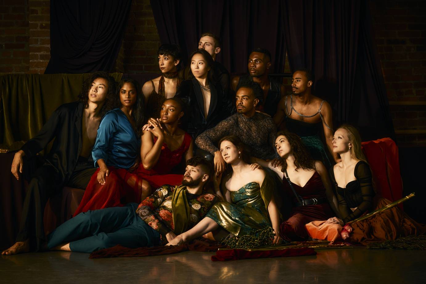 the company of dancers posed in various dress costumes