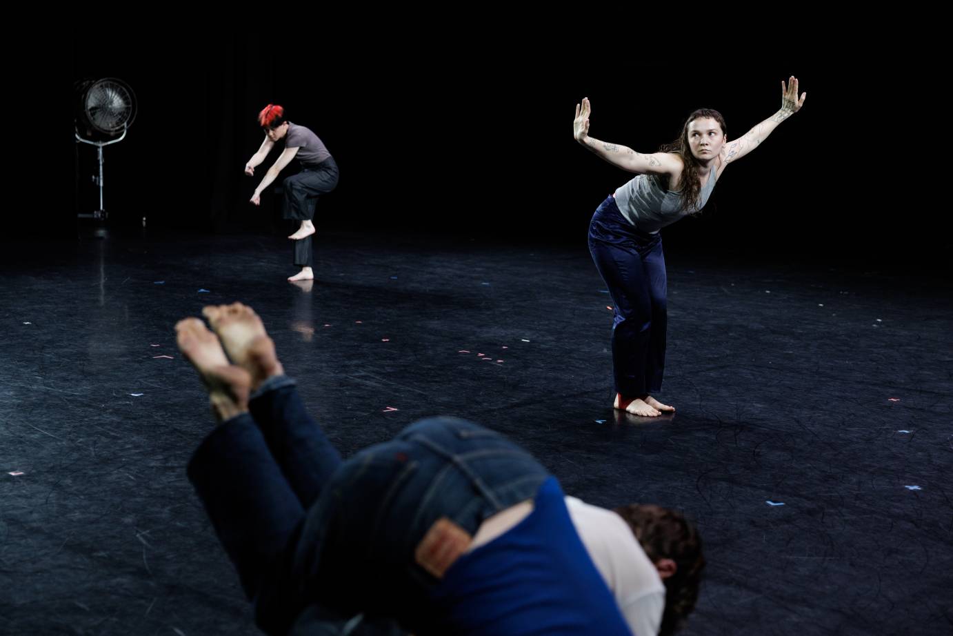 quartet in all denim perch in seperate areas of the stage inhabitants in their own world 