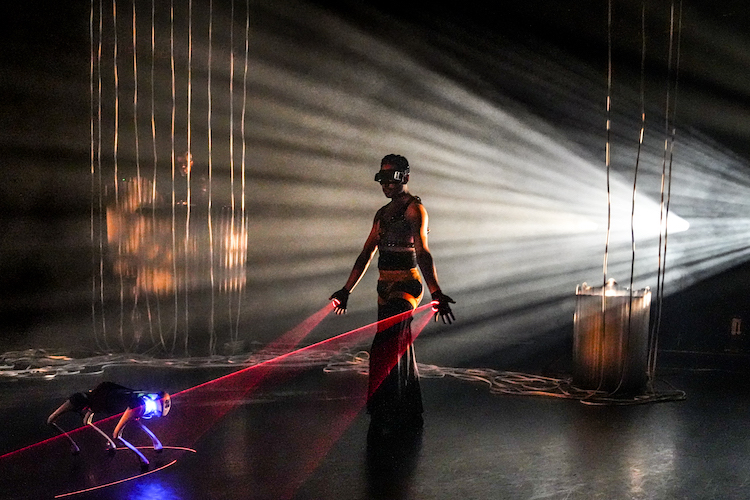 man with goggles, surrounded by lights, red light rays emitting from his palm staring at a robotic dog