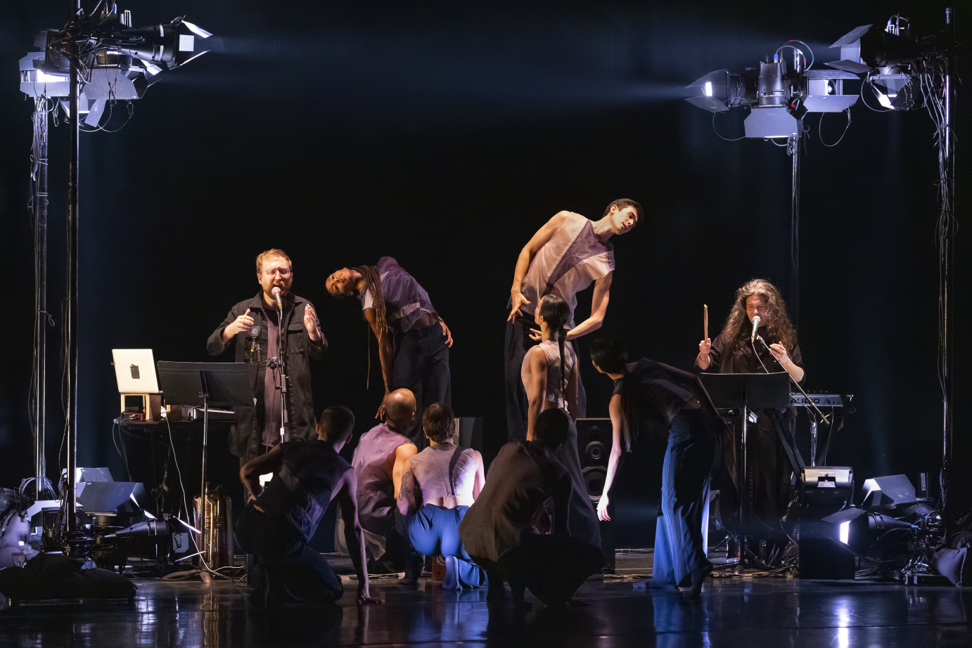 Dancers kneel and bend their spines as The Bengsons sing.